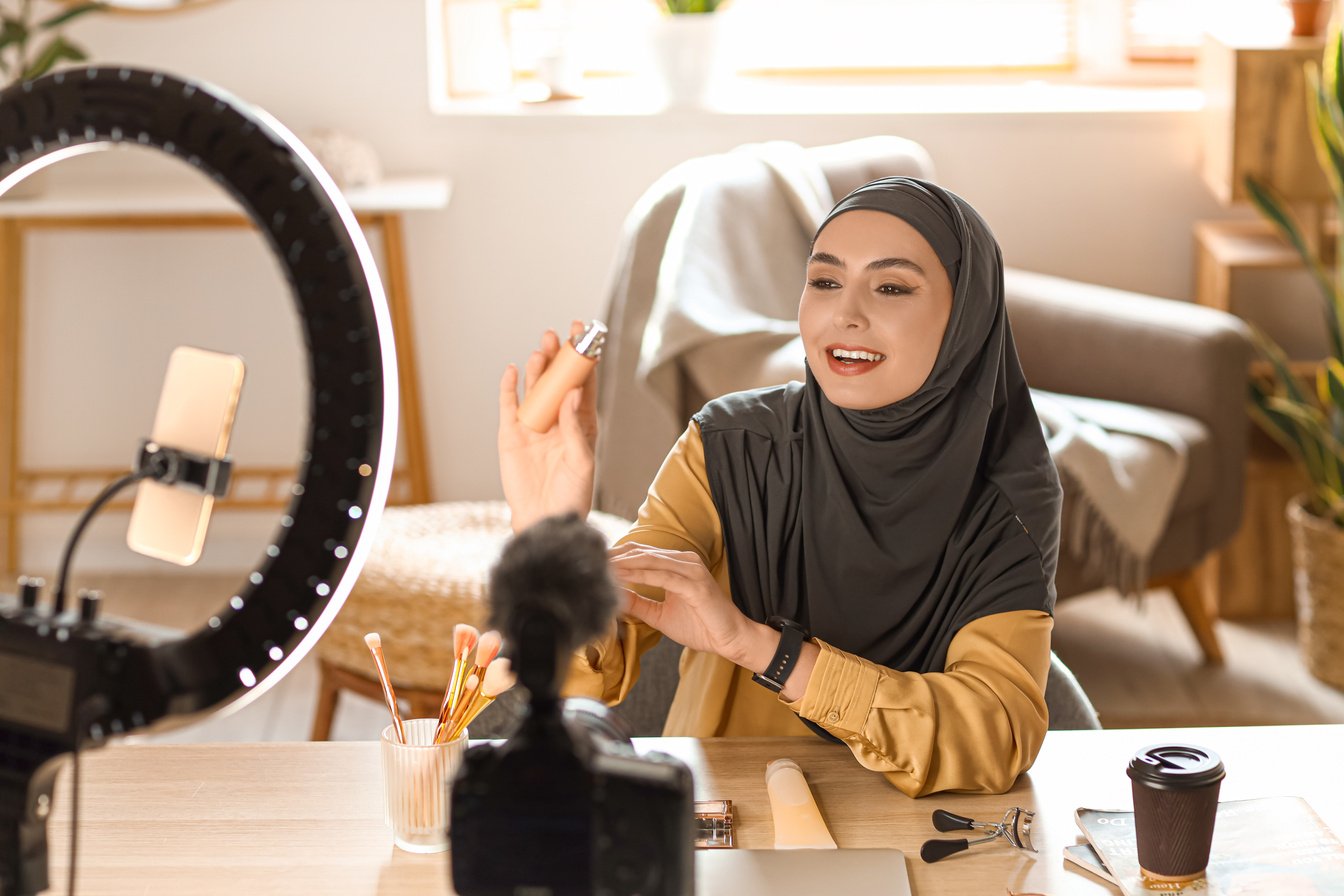 Muslim Beauty Blogger with Perfume Recording Video at Home